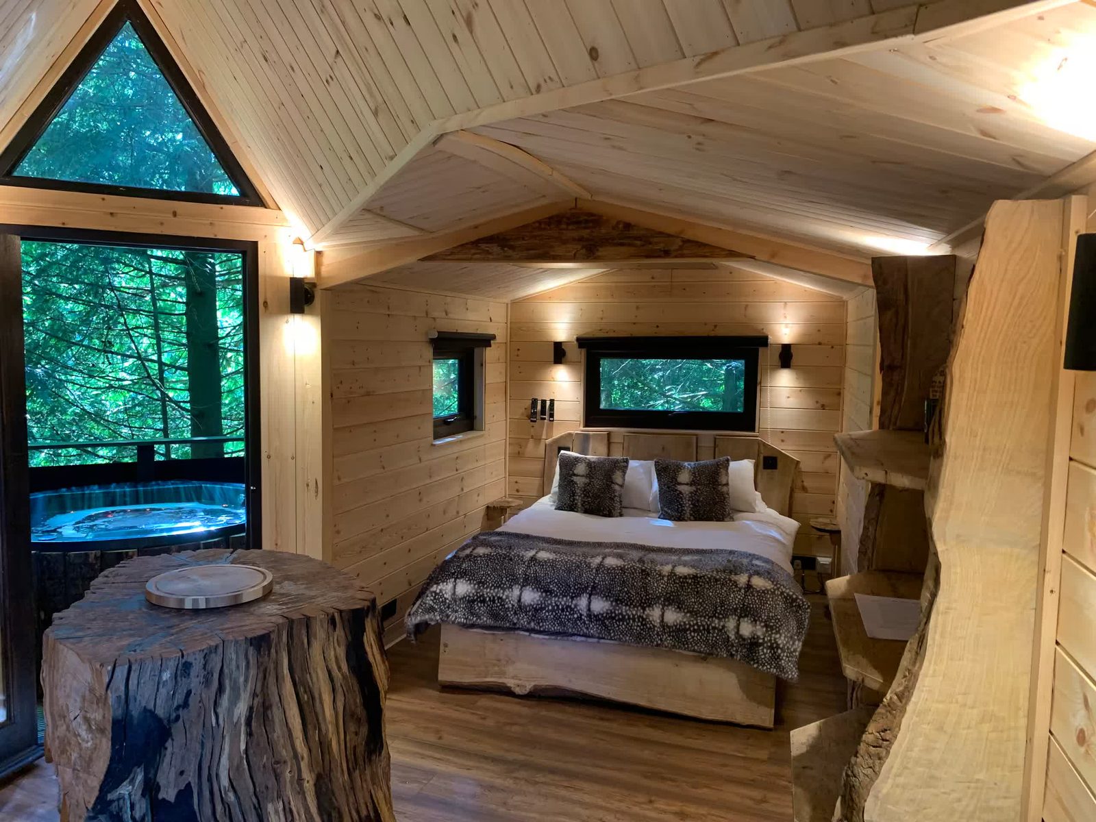 Bedroom with a private hot tub view