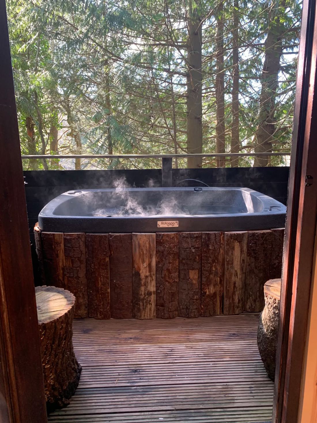 Hot tub on the deck, steaming among the trees